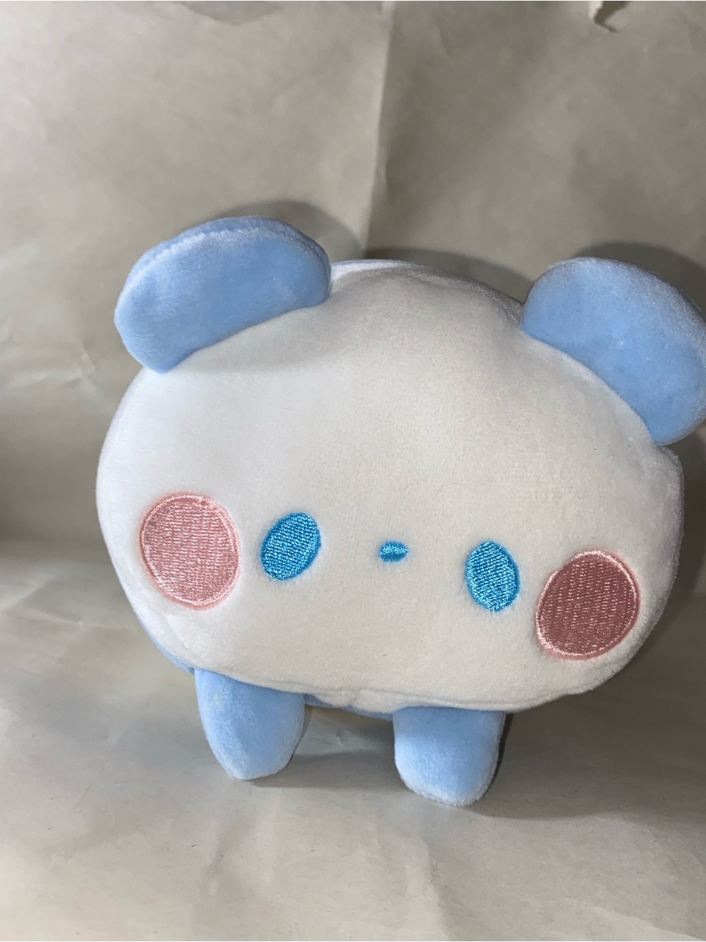 Mochi fuwa panda plush on blue
